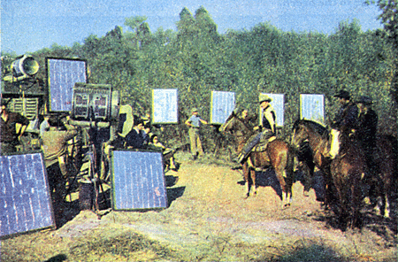 Roy Rogers on location for "Under California Stars" ( '48). The tin foil squares are light reflectors.