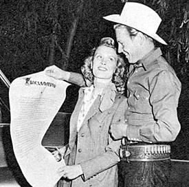 Rex Allen proudly shows his wife, Bonnie, the scroll presented to him in the inaugural ceremony naming him honorary mayor of Studio City.