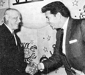 Dale Robertson receives a hardy greeting from Elmer Rhoden, chairman of the board of Commonwealth Theaters on March 29, 1965. Rhoden says he "discovered Robertson and brought him to the attention of Darryl Zanuck."