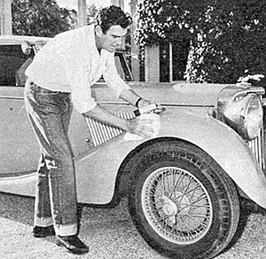 Rod Cameron polishes his car in the driveway of his home in 1950.