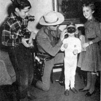 Also in Austin, Clayton Moore entertains the children at the home of Governor Allan Chivers.