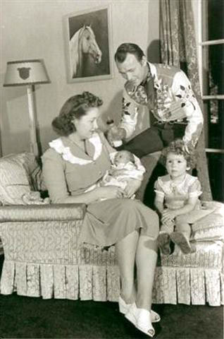 Roy and wife Arline at home with nine week old Linda Lou and 3 year old Cheryl. Note the painting of Trigger (or is it Little Trigger?) on the wall done by famous Danish western painter Olaf Wieghorst. It was painted by Wieghorst before he became famous. He'd been a policeman in New York City which is where Roy met the artist during one of his early Madison Square Garden appearances. The painting was sold after Roy and Dale's deaths at a High Noon auction in Mesa, Arizona for $25,000. (Thanks to Bobby Copeland, Mike Johnson, Leo Pando.)