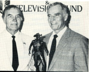 George Montgomery (left) presents Charleton Heston with the 1992 Hollywood Westerner Hall of Fame President Reagan Award. The bronze, created by George, recognizes actors for lifetime achievement in westerns.