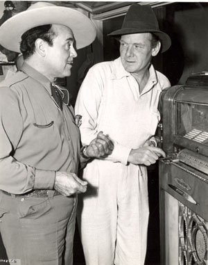 Leo Carrillo and Charles Bickford find a little diversion with a jukebox inbetween scenes for Universal’s “Riders of Death Valley” serial (‘41) filmed around Mojave, California.