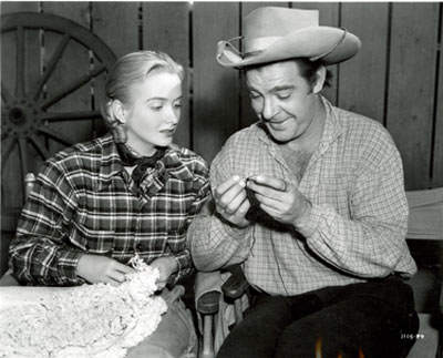 Definite incongruity here as Lon Chaney Jr. shows Jeanne Kelly the intricacies of tatting (a technique for handcrafting a particularly durable lace constructed by a series of knots and loops) between scenes for the Universal serial “Riders of Death Valley” (‘41).
