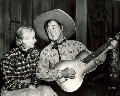 Leo Carrillo serenades Jeanne Kelly in this off-stage shot during the making of “Riders of Death Valley” (‘41).