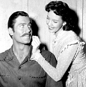 Clint Walker and Sally Fraser clown around on the set of “Cheyenne: The Trap” (‘56).