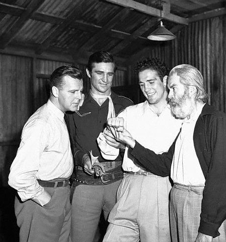 Light Heavyweight boxing champion Billy Conn, known as The Pittburgh Kid, lets Neil Hamilton, Sammy Baugh and Gabby Hayes take a look as his strong right hand during the making of the Republic serial “King of the Texas Rangers” in July 1941.