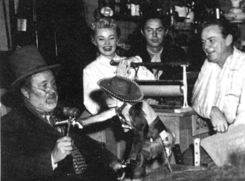 Monkeying around on the “Judge Roy Bean” set during the filming of the “Citizen Romeo” episode regarding a organ grinder’s monkey are (L-R) Edgar Buchanan as Judge Roy Bean, Jackie Loughery as Letty Bean, Jack Beutel as Jeff Taggard and producer Russell Hayden (who often played Texas Ranger Steve).