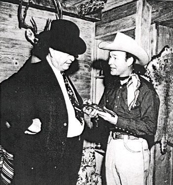 Legendary Captain Frank Hamer of the Texas Rangers and Roy Rogers examine a pistol at Roy’s home. Hamer and others ambushed the notorious Bonnie and Clyde near Gibsland, LA, on May 23, 1934. 
