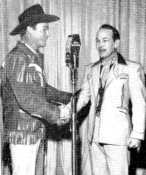 Roy Rogers congratulates Spade Cooley on his new television show originating from the Santa Monica Ballroom in California in 1948.