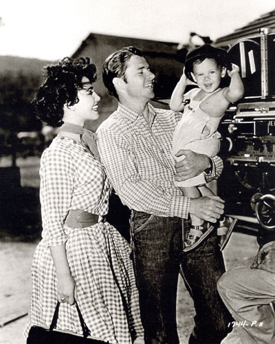 Seventeen month old Terry Murphy is the guest of his Dad Audie Murphy and co-star Susan Cabot on the set of "Ride Clear of Diablo" ('53 Universal-International).