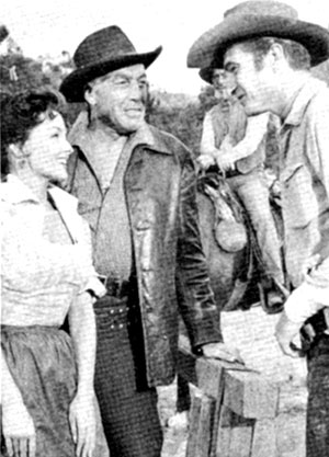 Mari Blanchard and Cesar Romero talk with Eric Fleming during a break from the filming of “Rawhide: Incident of the Stalking Death” in November 1959. Note Paul “Wishbone” Brinegar on horseback in the background.