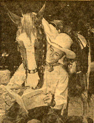 Eddie Dean and his horse study the script for “In Old Wyoming” which became “Song of Old Wyoming” (‘45).