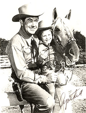 A young Cynthia Hale with her dad, Johnny Mack Brown, and his horse Rebel.