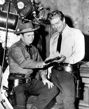 Wayde Preston (R), star of Warner Bros. TV series “Colt .45”, gets some pointers on handling a sixgun from Arvo Ojala, the acknowledged dean of Hollywood's gun-coach experts.