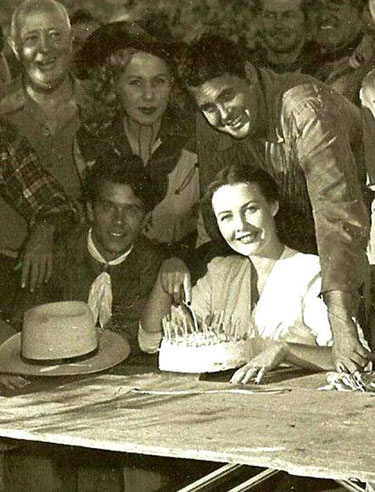 A birthday party for Sunset Carson’s wife sometime in 1948-‘49 while Sunset was making his low budget series for Yucca Pictures. Sunset’s kid brother, Dale Harrison, is on the left, above him is leading lady Pat Starling. (Thanx to Bobby Copeland.)