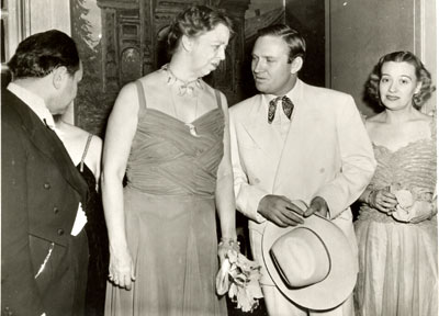 Eleanor Roosevelt and Gene Autry in a photo taken January 30, 1940, during a week in Washington, D.C., celebrating President Roosevelt's 58th birthday. (Is that Edward G. Robinson on the left?) Other celebrities invited to Washington for the ten day celebration included Olivia de Havilland, Mickey Rooney and Tyrone Power. Gene's January 28 "Melody Ranch" broadcast originated from the Press Club auditorium where he was joined by Eleanor in a patriotic tribute. (Thanx to Neil Summers.)