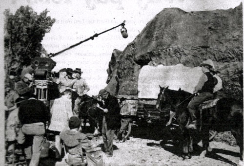 Filming a "Wagon Train" episode in the Conejo Valley west of Los Angeles. Robert Horton and Ward Bond can be seen left of the rock formation. Frank McGrath leans against the wagon. (Thanx to Terry Cutts.)