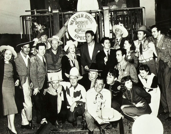 Warner Bros.’ gang at the premiere of “Dodge City” in 1939. Group includes Errol Flynn in the center, Gilbert Roland, Maxie Rosenbloom, Hoot Gibson, Buck Jones, Big Boy Williams, Humphrey Bogart, Frank McHugh, Wayne Morris, Priscilla Lane, John Payne, John Garfield, Jim Thorpe, Jean Parker and others.. (Thanx to Jerry Whittington.)