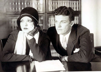 Hollywood’s “IT” girl, Clara Bow, and husband-to-be, B-Western star Rex Bell, listen intently to court proceedings in January 1931. Bow was being accused by her former secretary, Daisy De Voe, of “large capacities both as to histrionic and alcoholic abilities.” De Voe demanded $125,000 from Bow’s attorney for “Things I know” according to an asserted confession of De Voe. Bow charged De Voe with theft and misconstruing her life-style. On January 23, 1931 the jury convicted De Voe of grand theft on one of 35 counts Clara had filed against her. Bow and Bell were later married in December ‘31.