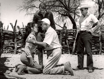 Director George Marshall shows Audie Murphy just how he should grab Kathryn Grant for a scene in Columbia’s “Guns of Fort Petticoat” (‘57) on location in Tucson, AZ. 
