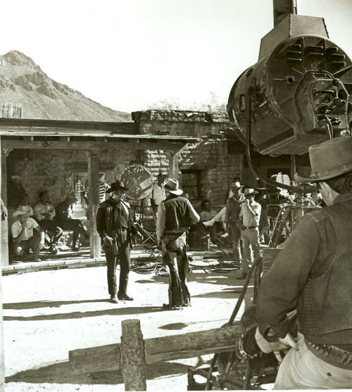 Cameron Mitchell surrounded by the crew during a scene for “High Chaparral”. Mark Slade on the right behind the camera. (Courtesy “High Chaparral” newsletter. info@highchaparralnewsletter.com) 