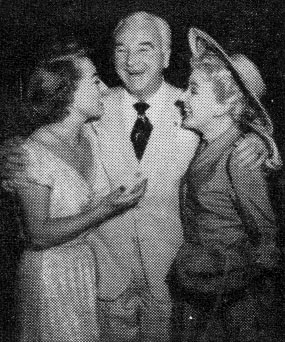 William Boyd gives a hug to actress Joan Crawford and wife Grace Bradley in mid-1951.