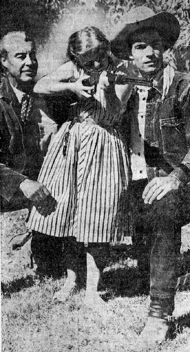 Eleven year old Marilyn Kington of Rockville, CT, received an A+ on her class assignment about Arizona, then got to visit the set of “26 Men” in Scottsdale, AZ. Tris Coffin (left) and Kelo Henderson give marksmanship pointers to Marilyn. 