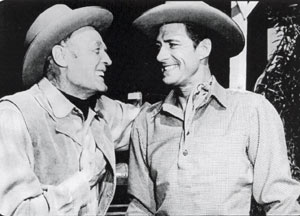 Forrest Taylor and Jock Mahoney converse during a break in filming from “Smoky Canyon” (‘52 Columbia).
