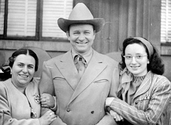 Photo from the Easter 1949 TEX RITTER TRAIL NEWS. Tex with fan club president Helene Meconi and secretary Frances Sturdivan.