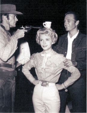 “At this range I can’t miss!”, sez Clint Eastwood as he clowns around with Ruta Lee and Eric Fleming on the set of “Rawhide”. (Thanx to Terry Cutts.)