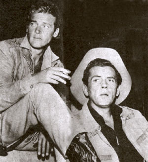 Cousin Beau Maverick (Roger Moore) and Bart Maverick (Jack Kelly) relax between takes on Warner Bros.’ ABC hit “Maverick”. (Thanx to Terry Cutts.)