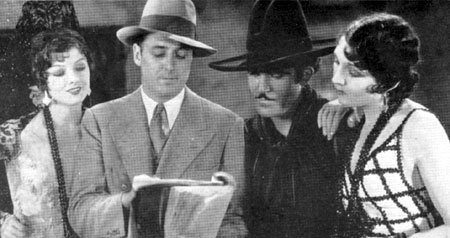 Director Spencer Bennet goes over the script for “Rogue of the Rio Grande” (‘30 World Wide) with Myrna Loy, Jose Bohr and Carmelita Geraghty. This was Bennet’s first talkie.