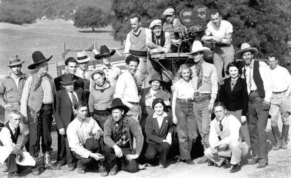 Cast and crew of “Sundown Trail” (‘34 Imperial). Star Wally Wales has his arm around leading lady Fay McKenzie. Director Bob Tansey is the tall man in the white shirt in the middle. His brother, actor James Sheridan (aka Sherry) Tansey stands on the far right next to the lady in the black jacket. Others unknown. (Thanx to Jerry Whittington.)