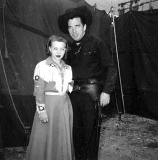 Lash LaRue poses with a fan at the High Point, NC, fair in 1958. (Thanx to Jerry Whittington.)