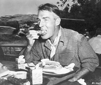 Randolph Scott munches on a chicken drumstick during a lunch break from filming ?? (Thanx to Terry Cutts.)