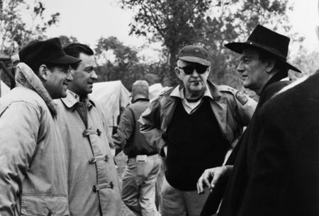 Together for the filming of “The Horse Soldiers” near Natchitouches, LA, are (L-R) unknown, William Holden, John Ford and John Wayne. 