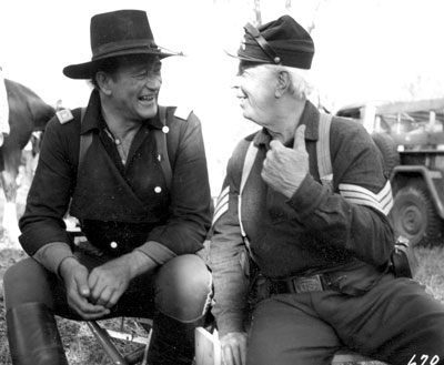 John Wayne and Hoot Gibson take a break from filming “The Horse Soldiers”.