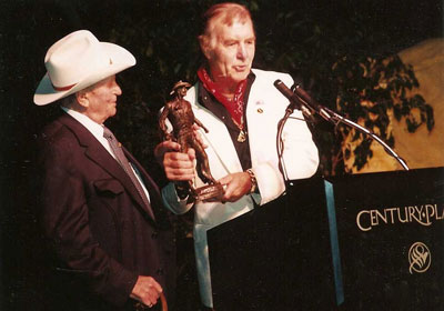 George Montgomery receives an award from Gene Autry during the 4th Autry Museum Gala 11/17/90 at the Century Park Hotel in L.A. (Thanx to Maxine Hansen, Autry Entertainment.)