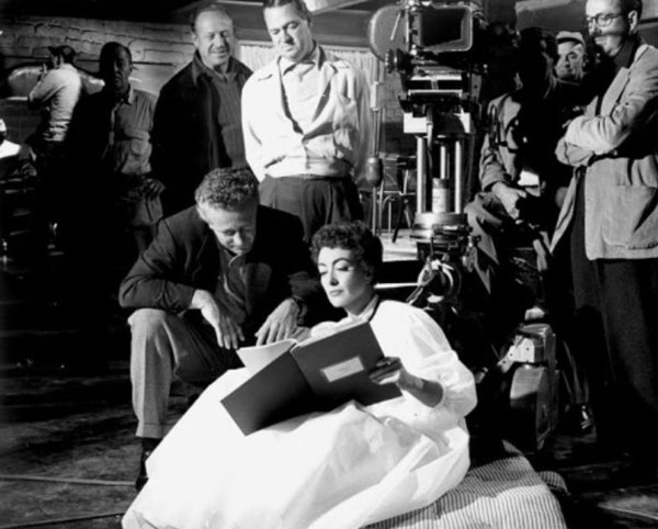 Joan Crawford goes over a “Johnny Guitar” script point with director Nicholas Ray. (Thanx to Jerry Whittington.)