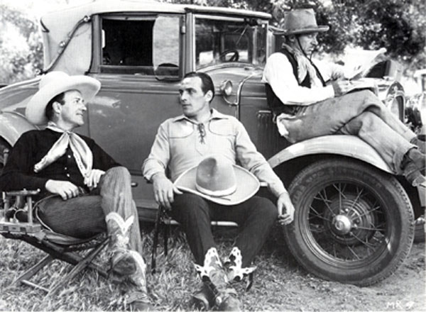 Jack Perrin and Tom Tyler chat during a break from filming "Mystery Ranch" ('34 Reliable) while character player Jimmy Aubrey catches up on the news. For whatever reason Perrin was billed Jack Gable in this film.