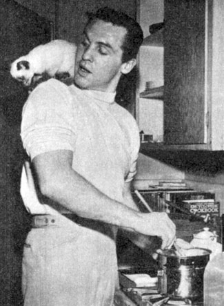 Pat Conway, grandson of actor Francis X. Bushman and star of “Tombstone Territory” as Sheriff Clay Hollister, was also a gourmet cook. Here, lured by the aroma of food, Phaugg, Conway’s kitten, perches atop Pat’s shoulder in 1959. 