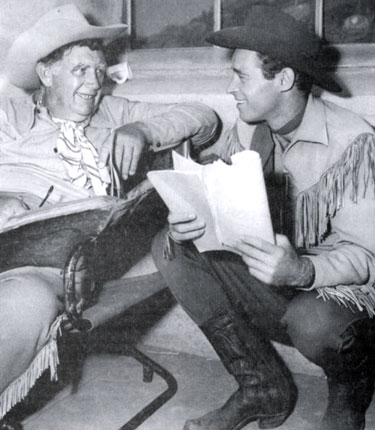 Andy Devine and Guy Madison check over their scripts for the next episode of “Wild Bill Hickok”. 