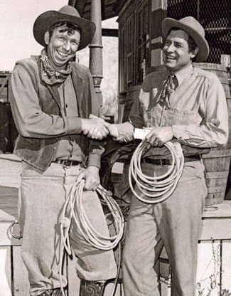 Slim Pickens (left) hands an award to Will Rogers Jr. making him an honorary member of the Rodeo Cowboys Association in 1952.