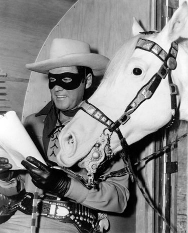 Clayton Moore studies his script for the big budget 1956 “Lone Ranger” movie.