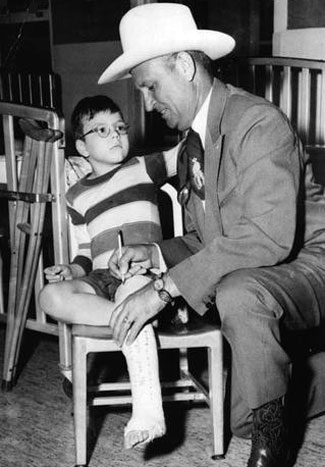 Gene signs a boy’s cast at the Shriner’s Hospital in 1958. (Thanx to Jerry Whittington.)