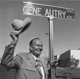 Gene Autry waves from in front of Gene Autry Trail, dedicated in Palm Springs, CA, in 1984.
