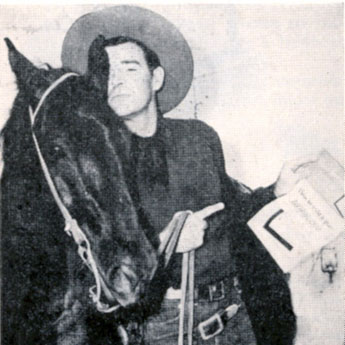 Rod Cameron feels it necessary to explain to his horse about the savings bond drive they were taking part in from May 15-June 30, 1949.