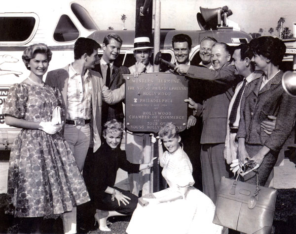 In 1959 this group of Warner Bros. stars were sent out to plug the movie “The Young Philadelphians”. None of the group was actually in the movie but they went all across the country in the tour bus seen in the photo. (L-R) Arleen Howell, Peter Brown, Troy Donahue, Will Hutchins, Roger Smith, Alan Hale Jr., the WB exec who was sending them off on the tour, Louis Quinn and Jacqueline Beer. Kneeling are Diane Jergens (married to Peter Brown from ‘58-‘60) and Connie Stevens. (Courtesy Will Hutchins.)